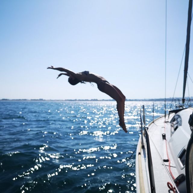 Catania: Coastline Sailing Trip 6hr with Aperitif and Lunch - Acicastello’s medieval castle from offshore